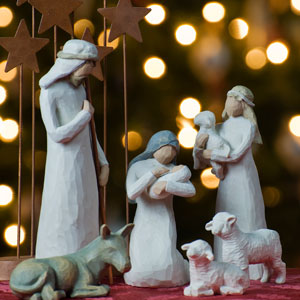 Depiction of nativity with Christmas tree in the background